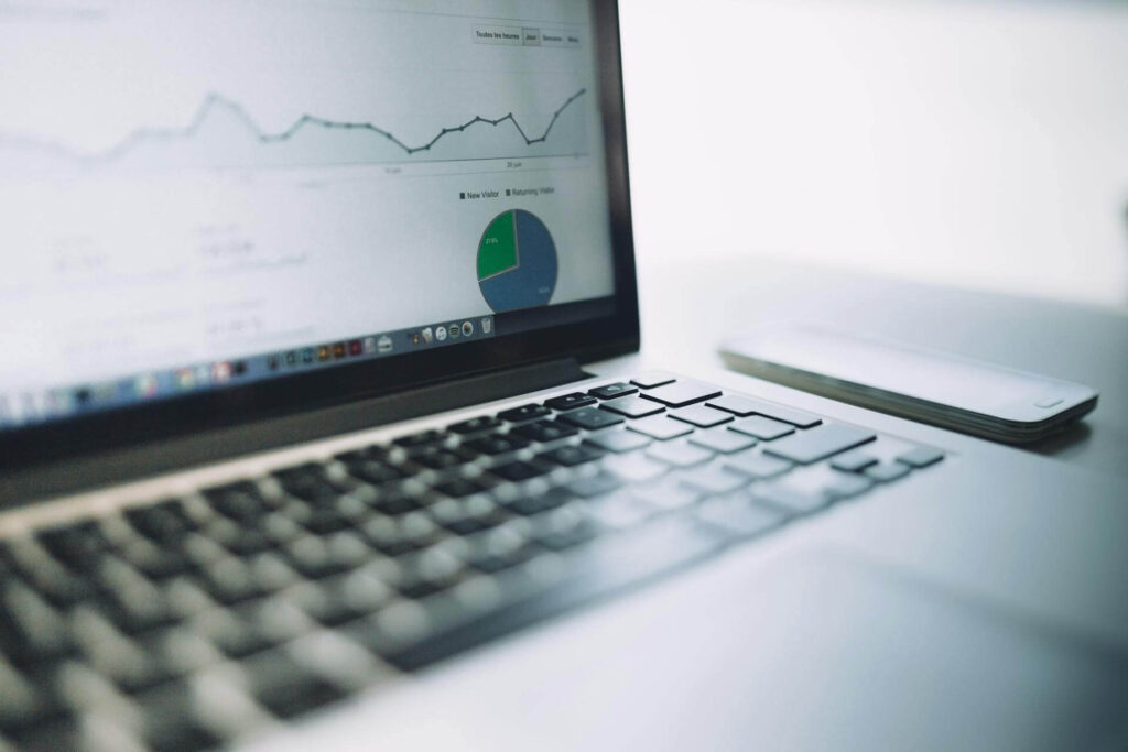 Läppäri, jonka näytöllä näkyy analytiikkaa ja hakukoneoptimoinnin tuloksia kuvaavia graafeja